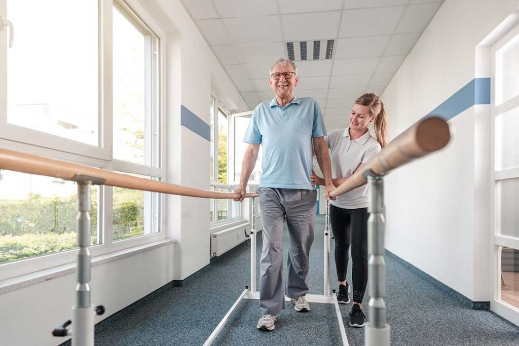 Adult practicing wall angels beside a home office while maintaining an upright posture.